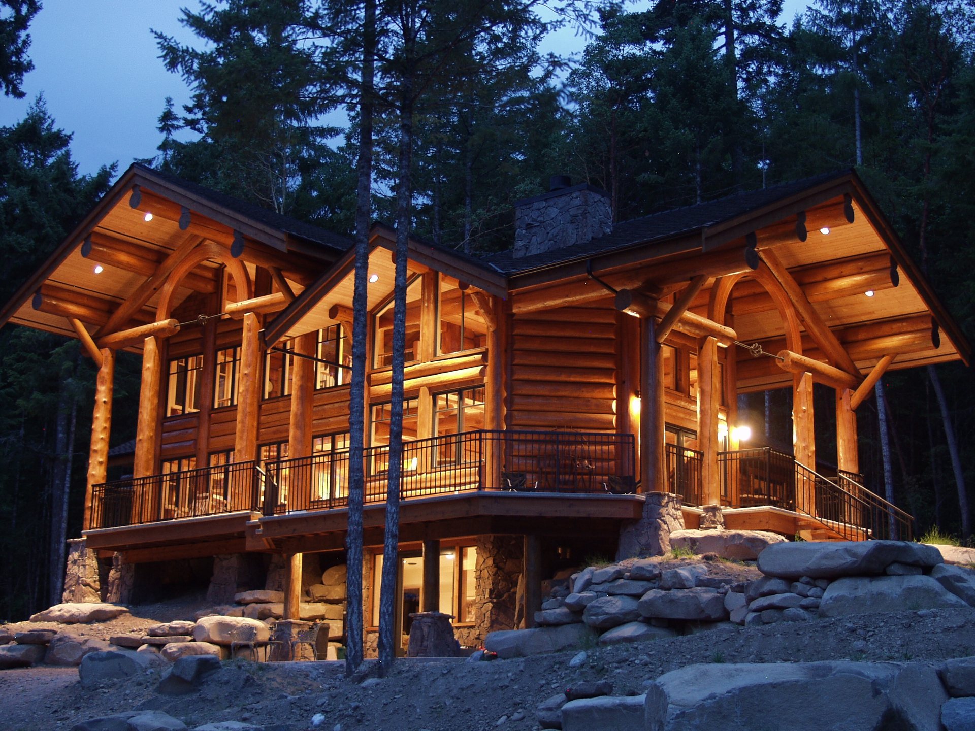 Log home lit at dusk